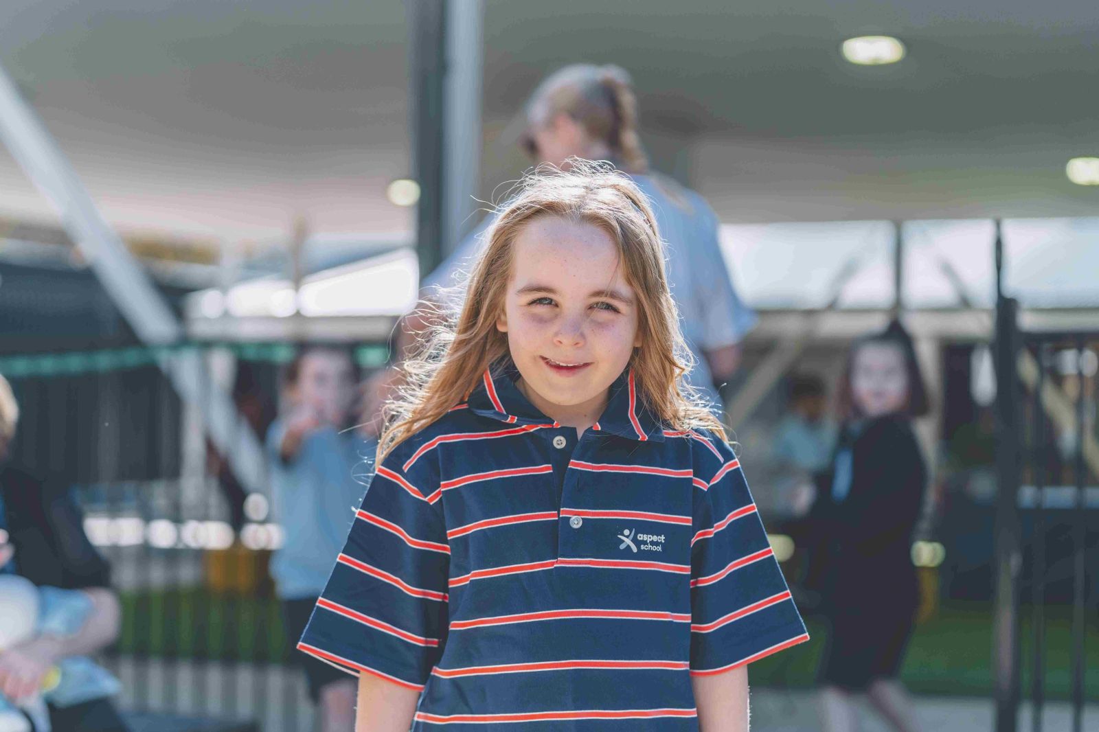 Student smiling outdoors during school day